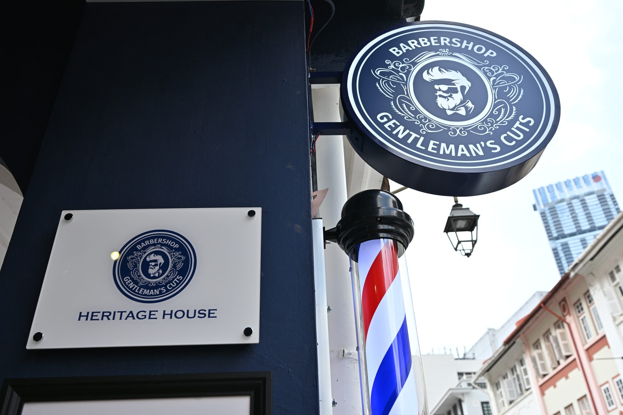 The Heritage House nameplate beside the barber pole